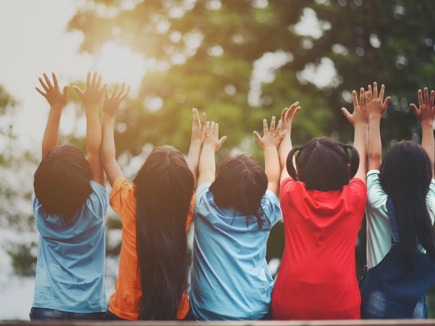 group-of-kids-friends-arm-around-sitting-together