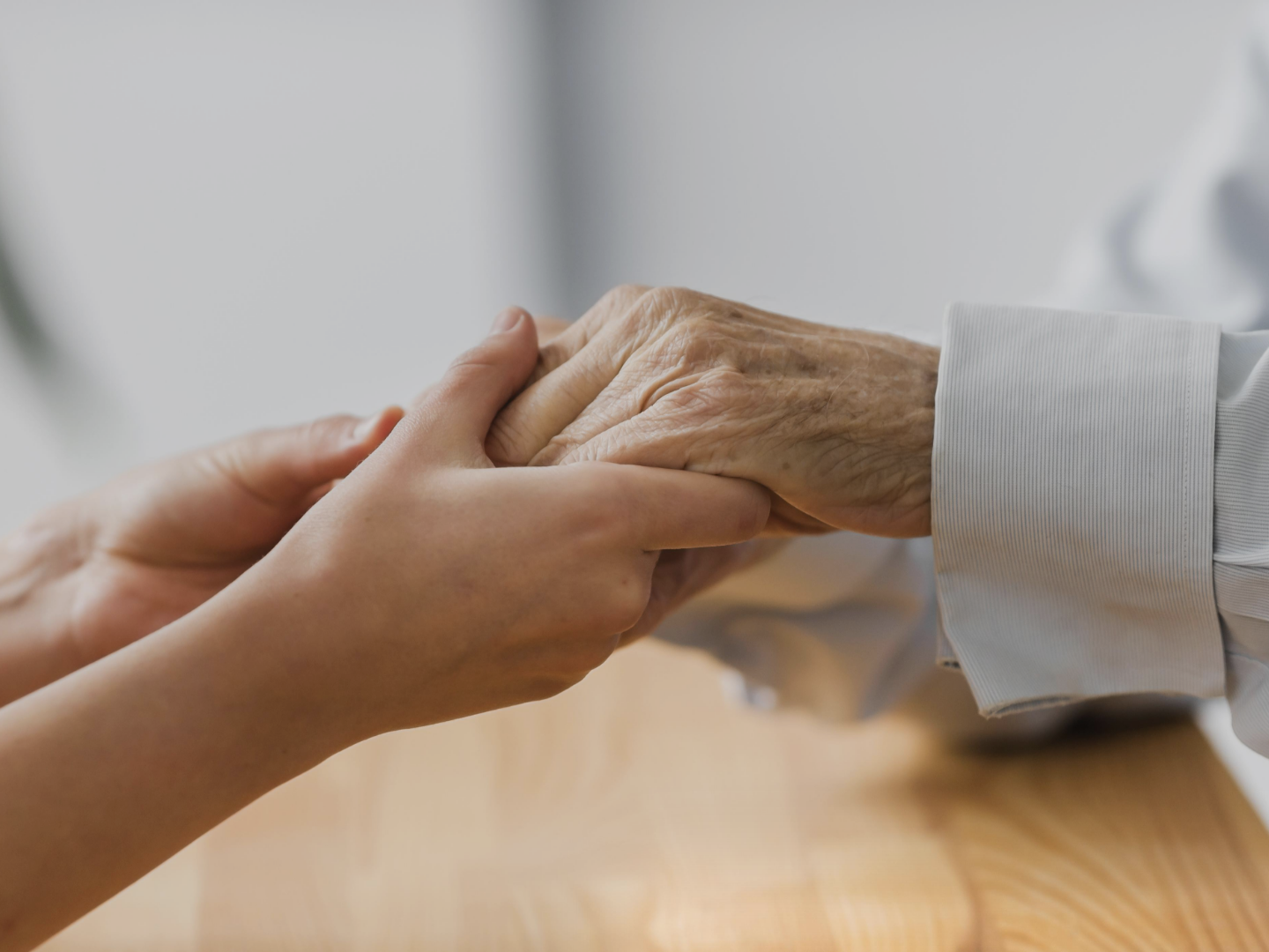 nurse-holding-senior-man-s-hands-for-comfort