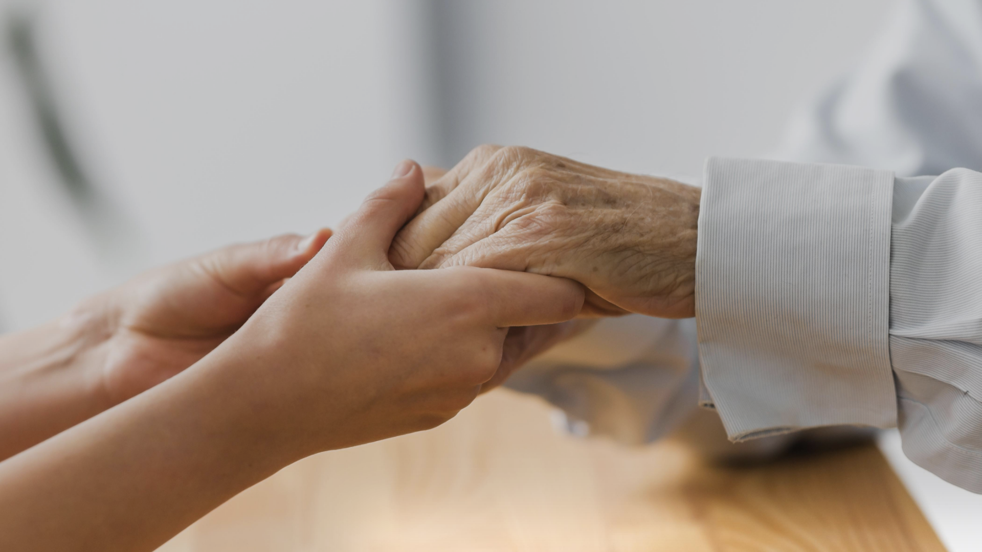 nurse-holding-senior-man-s-hands-for-comfort